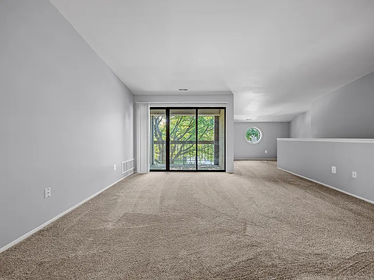 Gorgeous living room with balcony at Park Lane Apartments in Southfield, MI