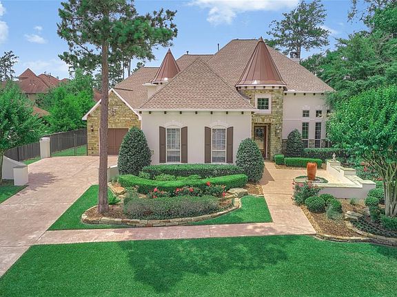 Welcome home to this exceptional Toll Brothers property located in The Woodlands, Creekside! This beautiful former model home sits on a large lot and has been extensively upgraded throughout! The home has a large driveway, wrought iron fencing and cu