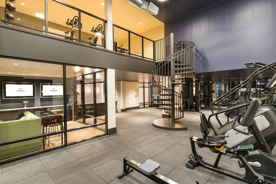 Stay active with ease in the two-level fitness studio at Modera Beaverton, featuring cutting-edge equipment and contemporary design.