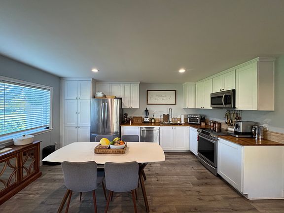 Stainless steel appliances with ample kitchen cabinet storage