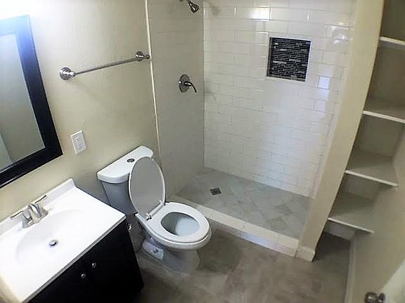 Bathroom 1 with fully tiled shower.