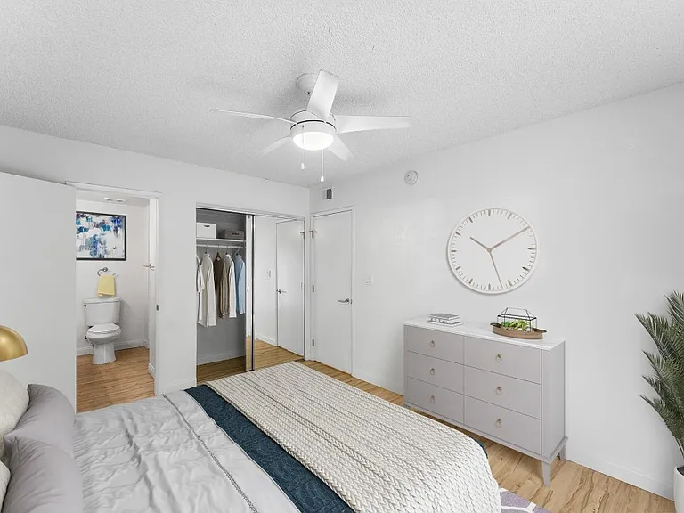 Mirrored wardrobe doors and ceiling fan.
