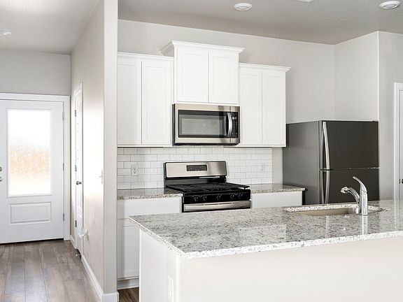 The kitchen of the Coastal has sprawling granite countertops.