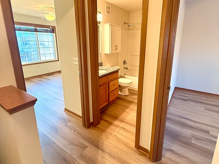 hall entry showing entrance into bathroom and two upstairs bedrooms