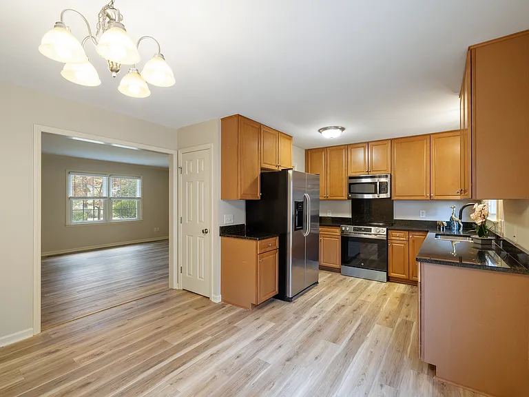Dinette/kitchen; granite countertops, upgraded appliances; half bath is tucked into back corner of kitchen
