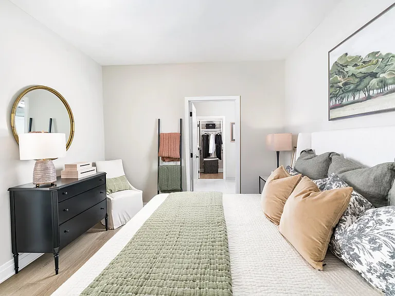 A spacious layout flows seamlessly into a walk-in closet, with soft tones and thoughtful finishes that make getting ready feel effortless.