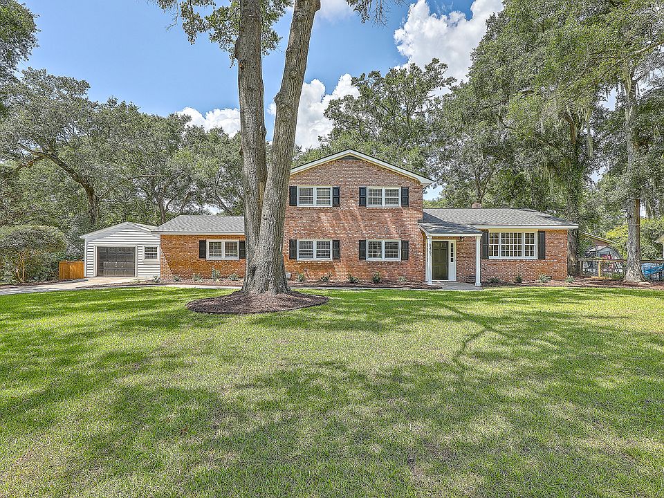 Freshly installed sod, mulch and plantings. Newly trimmed oaks.