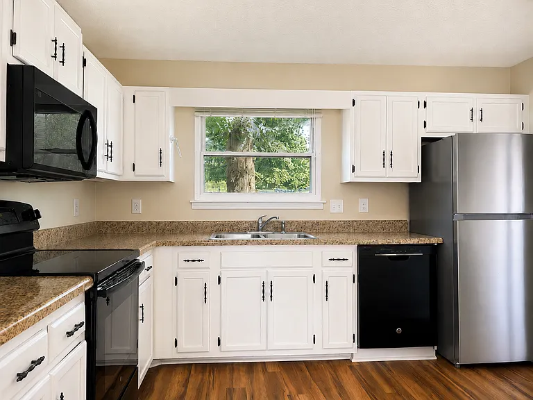 Kitchen with brand new refrigerator.