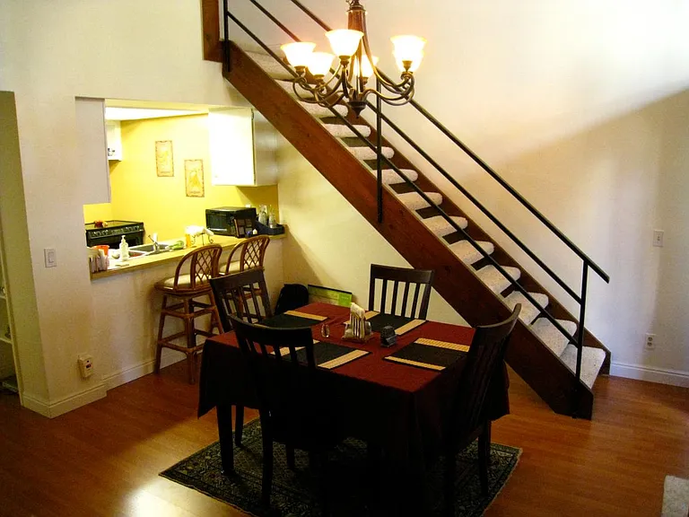 Stairs to the loft and view of kitchen