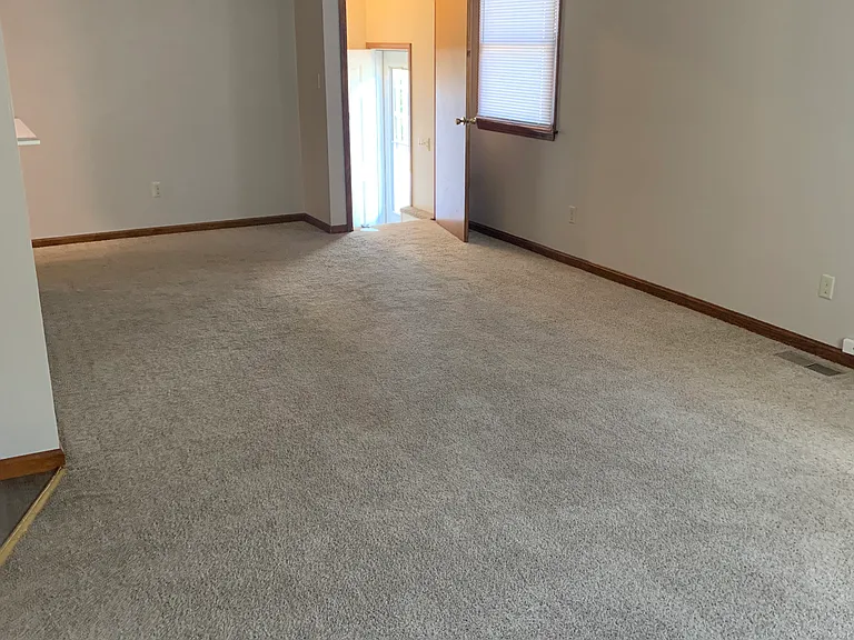 View from front of living room looking toward basement stairs