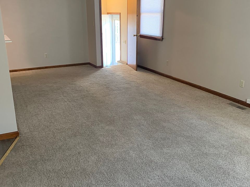 View from front of living room looking toward basement stairs