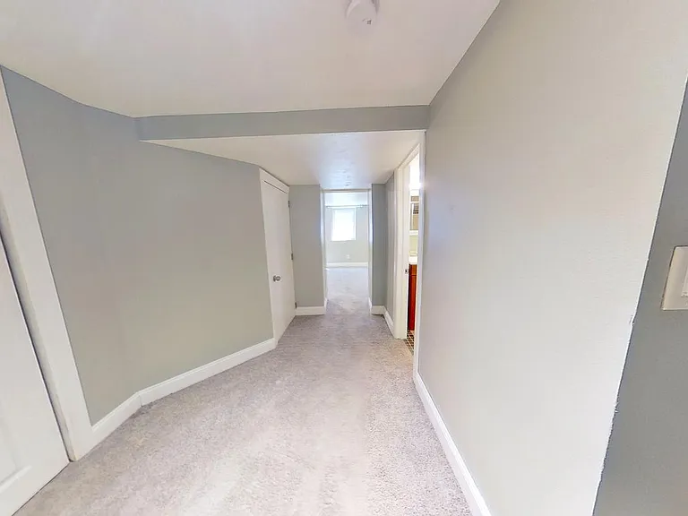 Hallway to Bedroom 5 on the lower level.