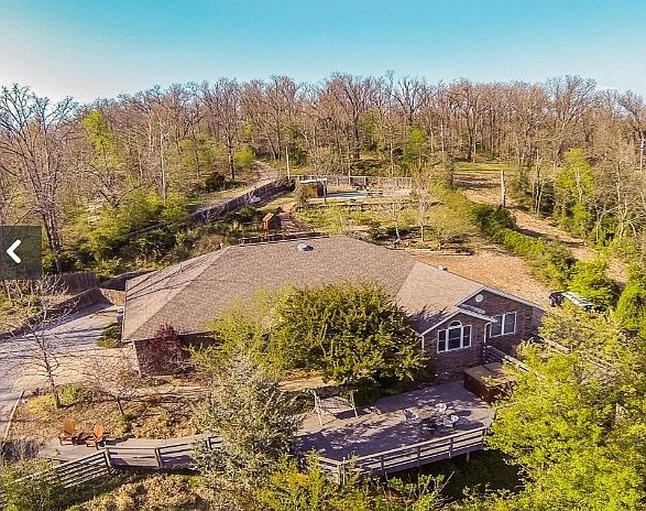 Aerial view of the property
						:
						Secluded but close to everything. 5 minutes to I-49, 10 minutes to the Mall