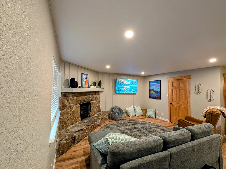 Living room with wood burning fire place and 65" TV