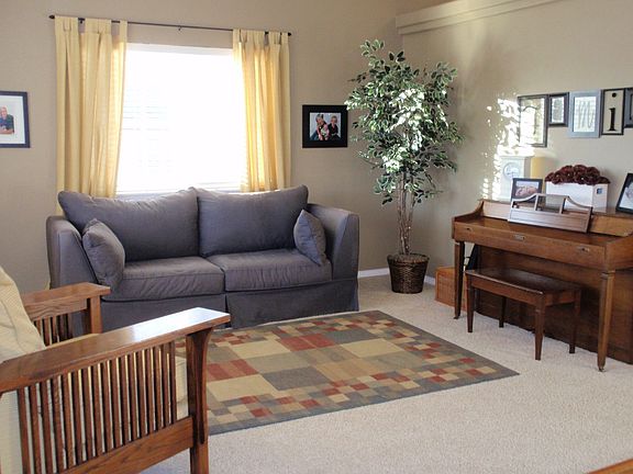 Living Room is bright & sunny with 2 large windows
