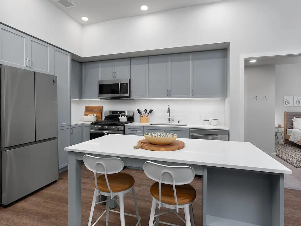 Building A Avalon Design kitchen with quartz countertops, stainless steel appliances, backsplash and island