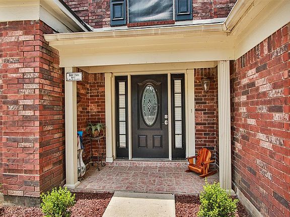 Welcome home - a charming pathway, decorative columns, landscaping, ambient lighting, and a beautiful front door create an exceptional arrival experience!