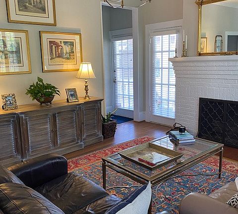 Image of the room with furniture & art. Full size couch and loveseat in the room