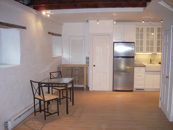 Kitchen/dining area. Little table and chairs and stainless/b