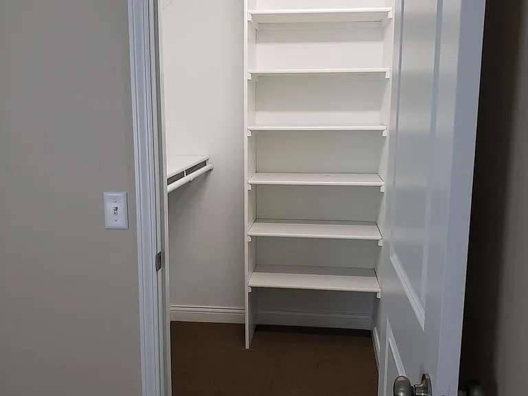 Bedroom Walk-In Closet with Double Poles/Shelves plus Built-In Shelves.