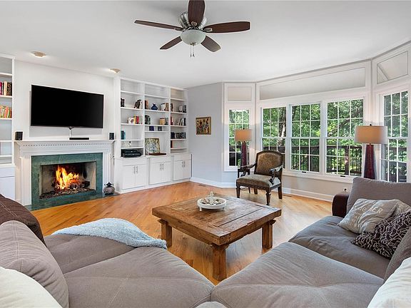 Spacious great room area with built-ins and bay window which overlooks the yard