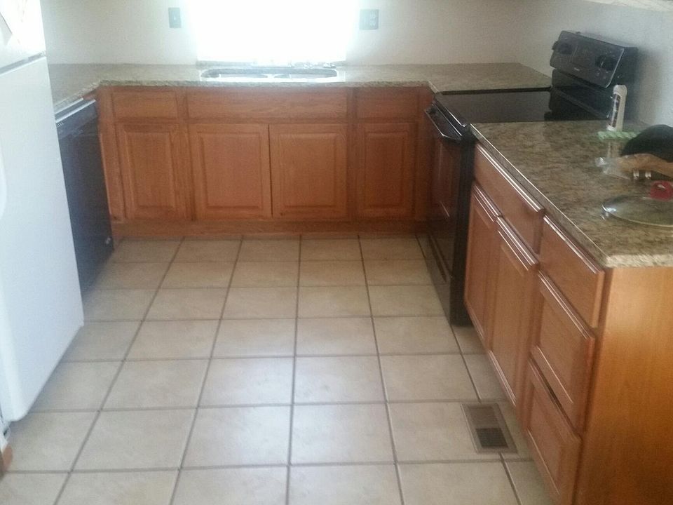 The kitchen white refrigerator will be put in garages to make room for new black refrigerator .