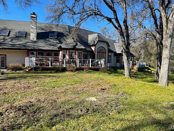 Back of house with many views of the majestic rolling hills on 30 acres and large trex deck with lounge chairs and an outdoor table that seats 6