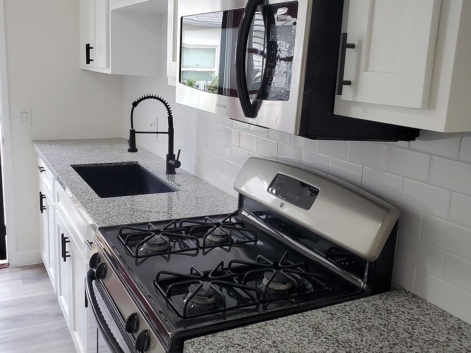Newly Renovated kitchen with granite countertops, stainless appliances , and farmhouse sink