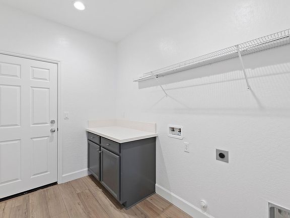 Laundry room by the single car garage