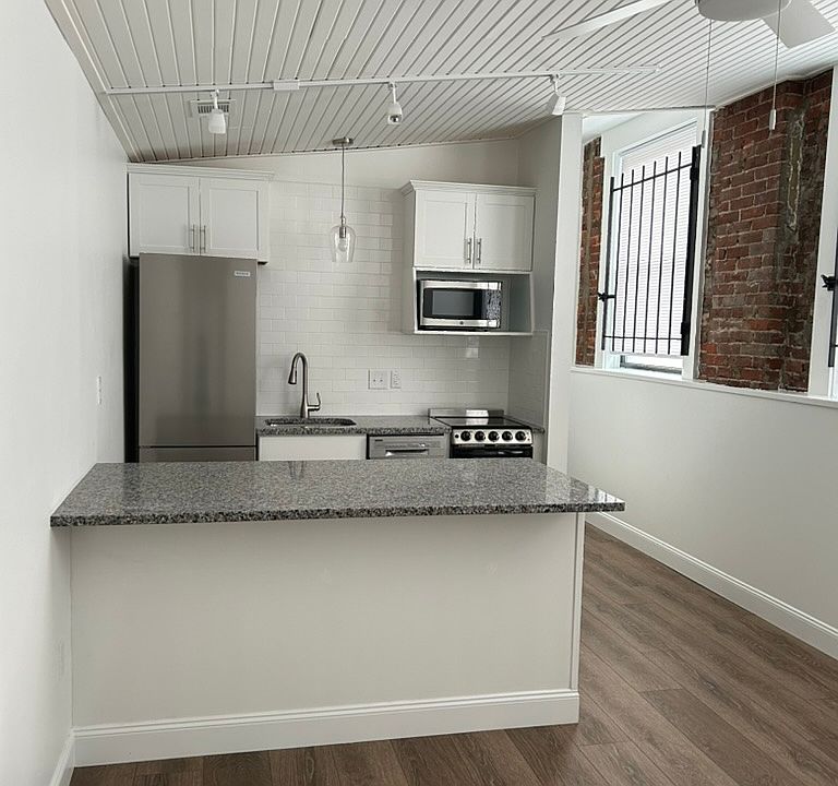 Large open plan kitchen/living area. Hardwood floors.