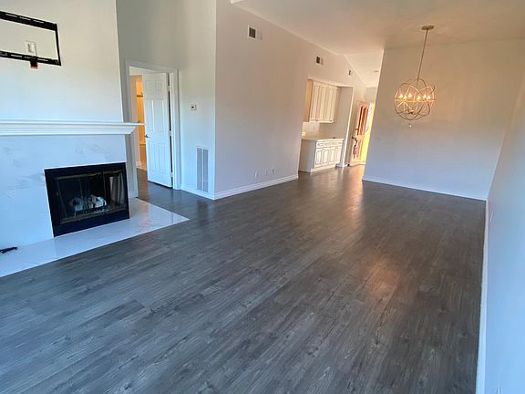 Open floor plan - living room and dining room. Space to mount your TV over the fireplace
