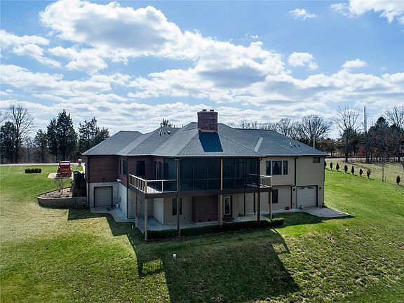 The home has two additional garages on the back side of the home.  Screened in porch, deck and pation on lower level.