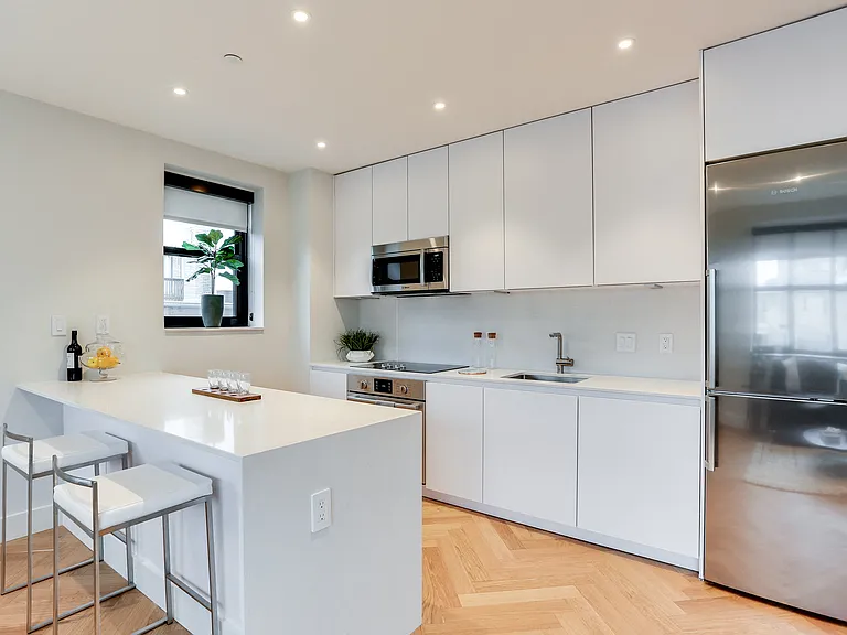 Custom kitchen with quartz countertops, hardwood floors and Bosch appliances