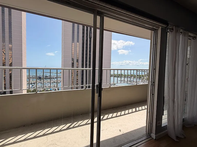 Oceanside view from living room with Ala Moana Beach Park/Magic Island in background
