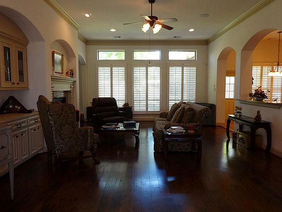 Welcome to the spacious family room with built-in bookcase & double-sided fireplace.
