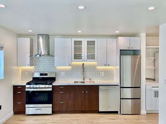 Open kitchen. View from living room area. Pull down faucet with a deep sink and garbage disposal. Full size stove and dishwasher for the home chef. All new GE appliances. Lots of storage.