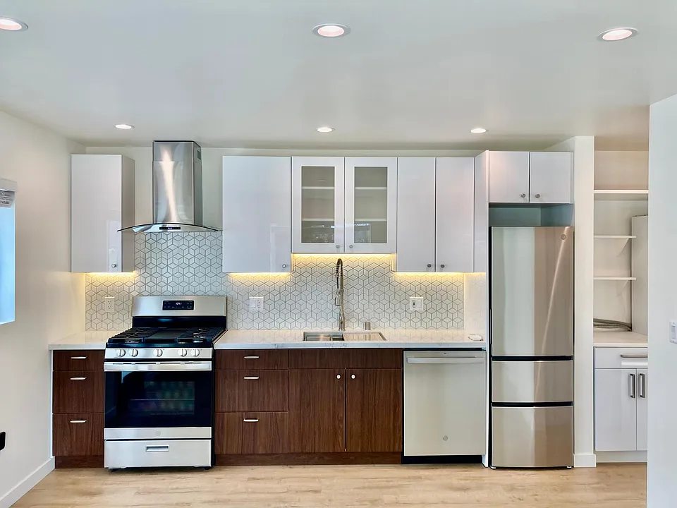Open kitchen. View from living room area. Pull down faucet with a deep sink and garbage disposal. Full size stove and dishwasher for the home chef. All new GE appliances. Lots of storage.