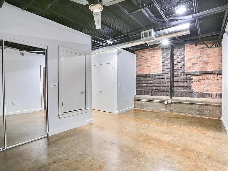 Unit 6: Front Room with Exposed Brick Accents
