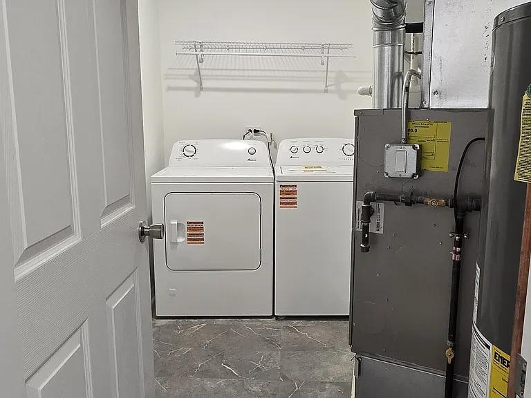 In-unit laundry room with washer and dryer