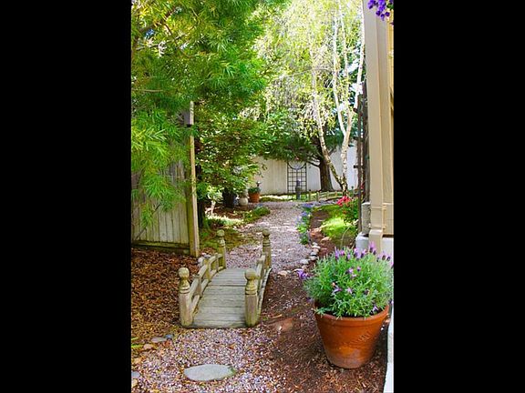 To the left of the front porch, serene "forest" side