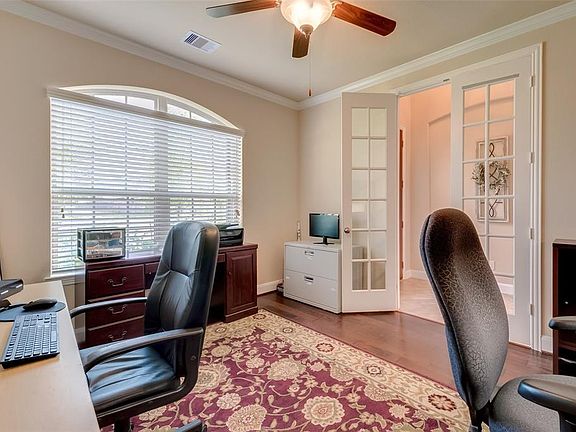 The study boasts a large arched picture window allowing in plenty of natural light. Gleaming hardwood flooring, crown molding and custom ceiling fan complete this room. Enjoy working from home in this private and peaceful setting.