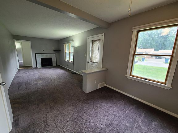 View of living room from dining room and out the windows to the front yard