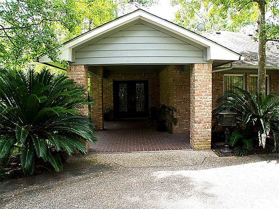 Mature sago palms flank the inviting front porch.
