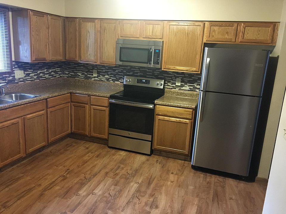 New cabinets, countertops and glass/stone tile backsplash.
