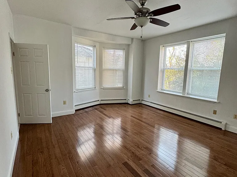Bedroom w/ beautiful hardwood flooring