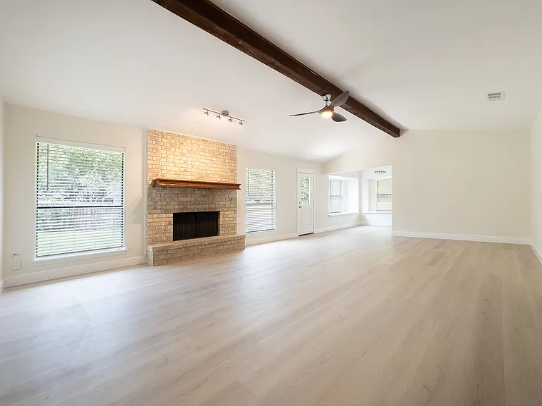Living room, complete with new lighting fixtures, new flooring, and gas fireplace.