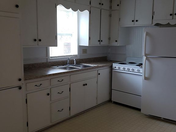 Kitchen showing fridge, stove and lots of cabinets.
