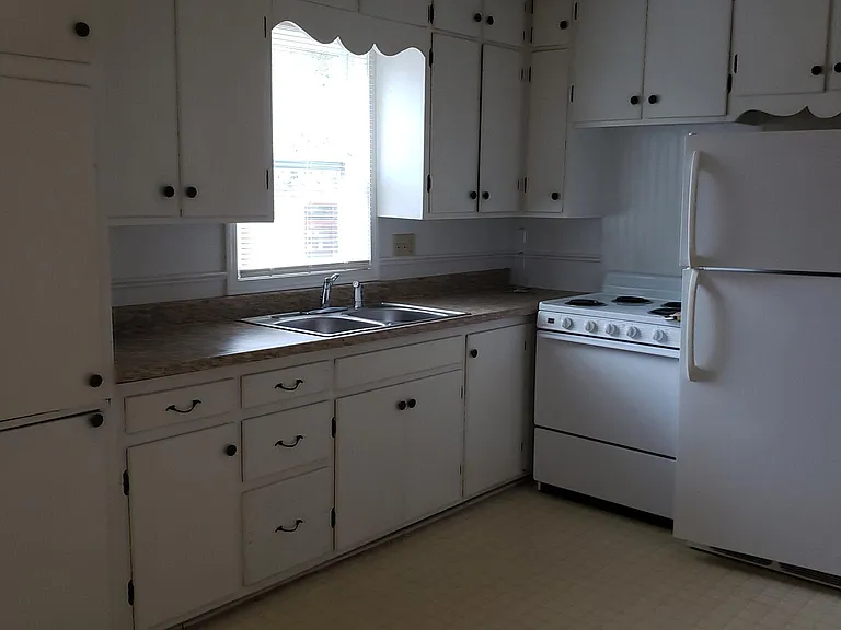 Kitchen showing fridge, stove and lots of cabinets.