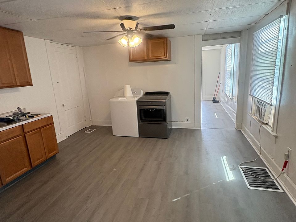 New vinyl flooring, paint, countertop, sink, ceiling fan and blinds.