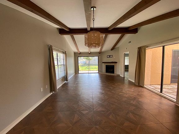 Fabulous Open Concept Great Room With Soaring Ceilings, Dramatic Wood Beams & Fireplace With Canal View!